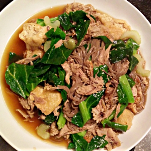 Noodle duck soup with spring greens and tofu puffs
