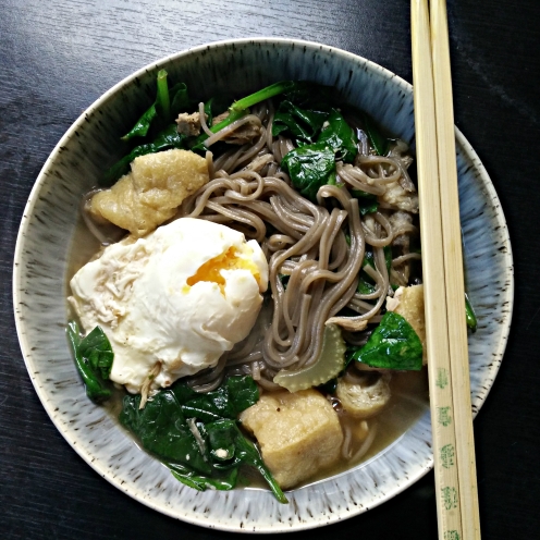 Buckwheat noodle soup with poached egg, spinach and tofu puffs